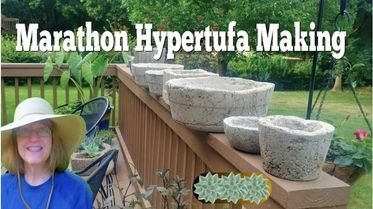 porch railing lined up with hypertufa pots