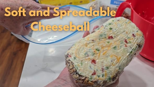 hand holding large oval cheeseball